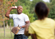 Man playing catch with his daughter