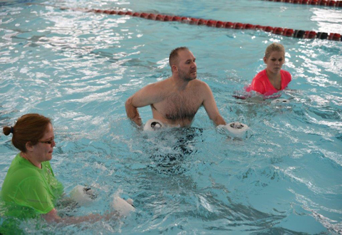 Veteran Darrin Groskrevtz, left, works with Chynna Flock, aquatic therapy instructor and physical therapy assistant, in the Tomah VAMC’s pool.